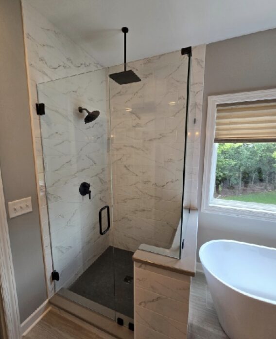 Frameless shower enclosure in matte black